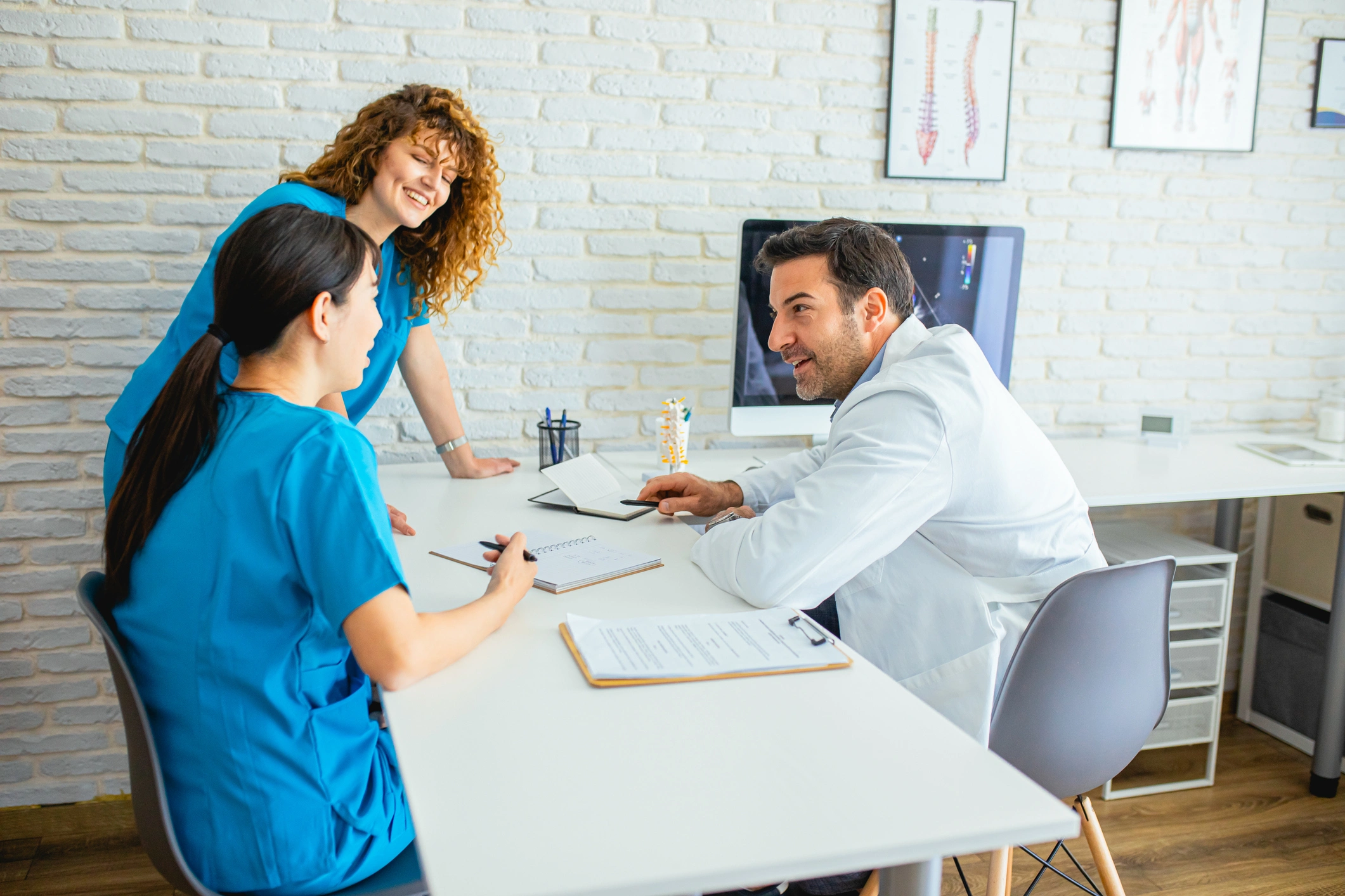 Doctors discussing patient notes in office