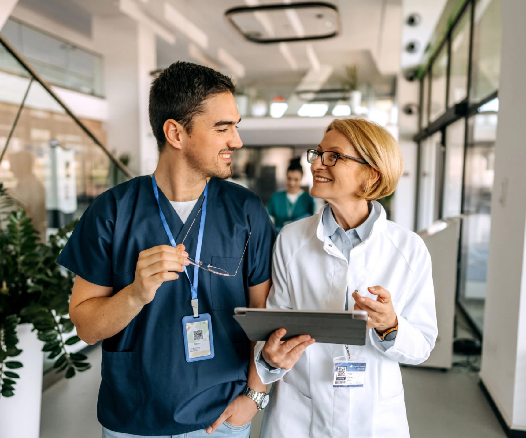 Healthcare workers sharing information with tablet