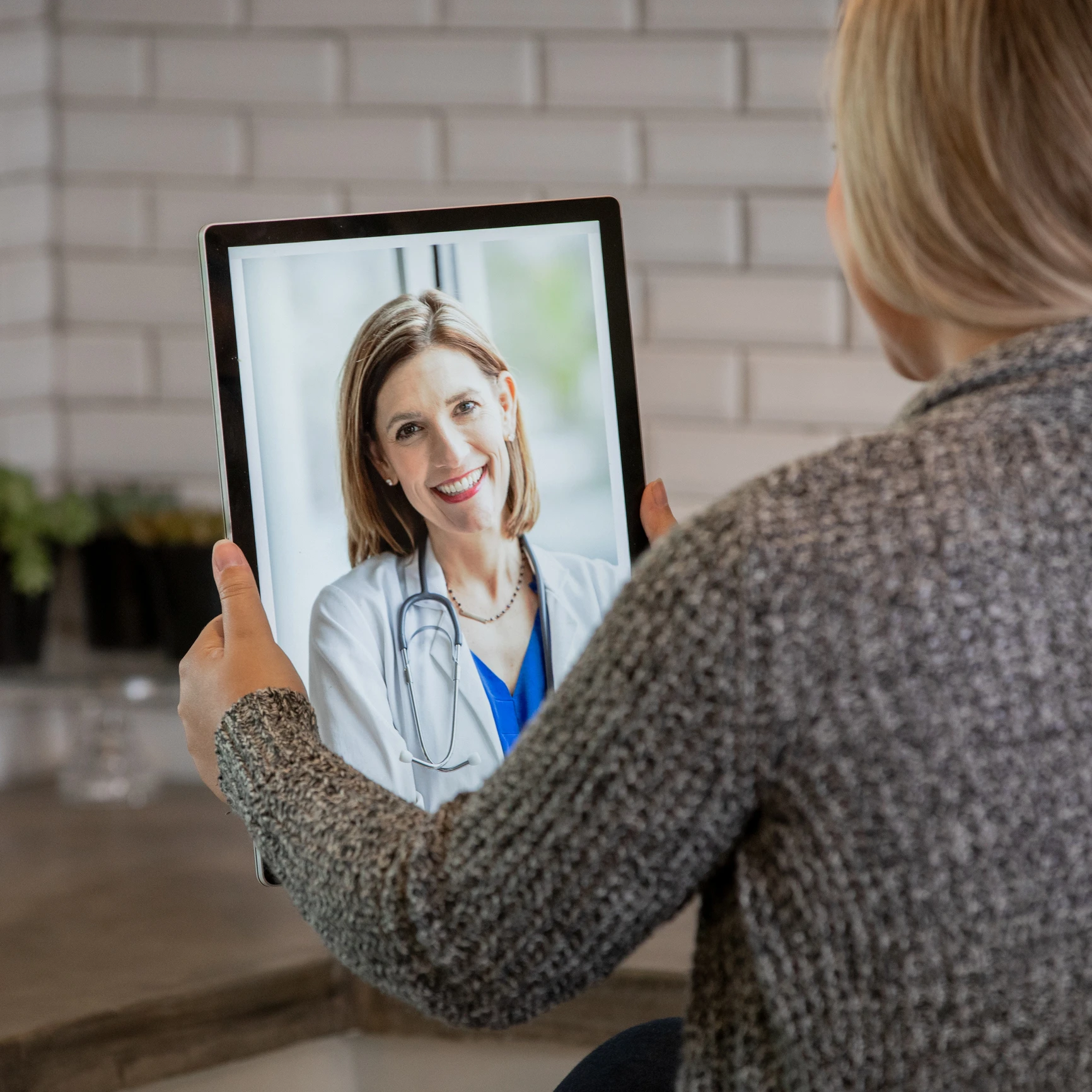 Video call with smiling female doctor.
