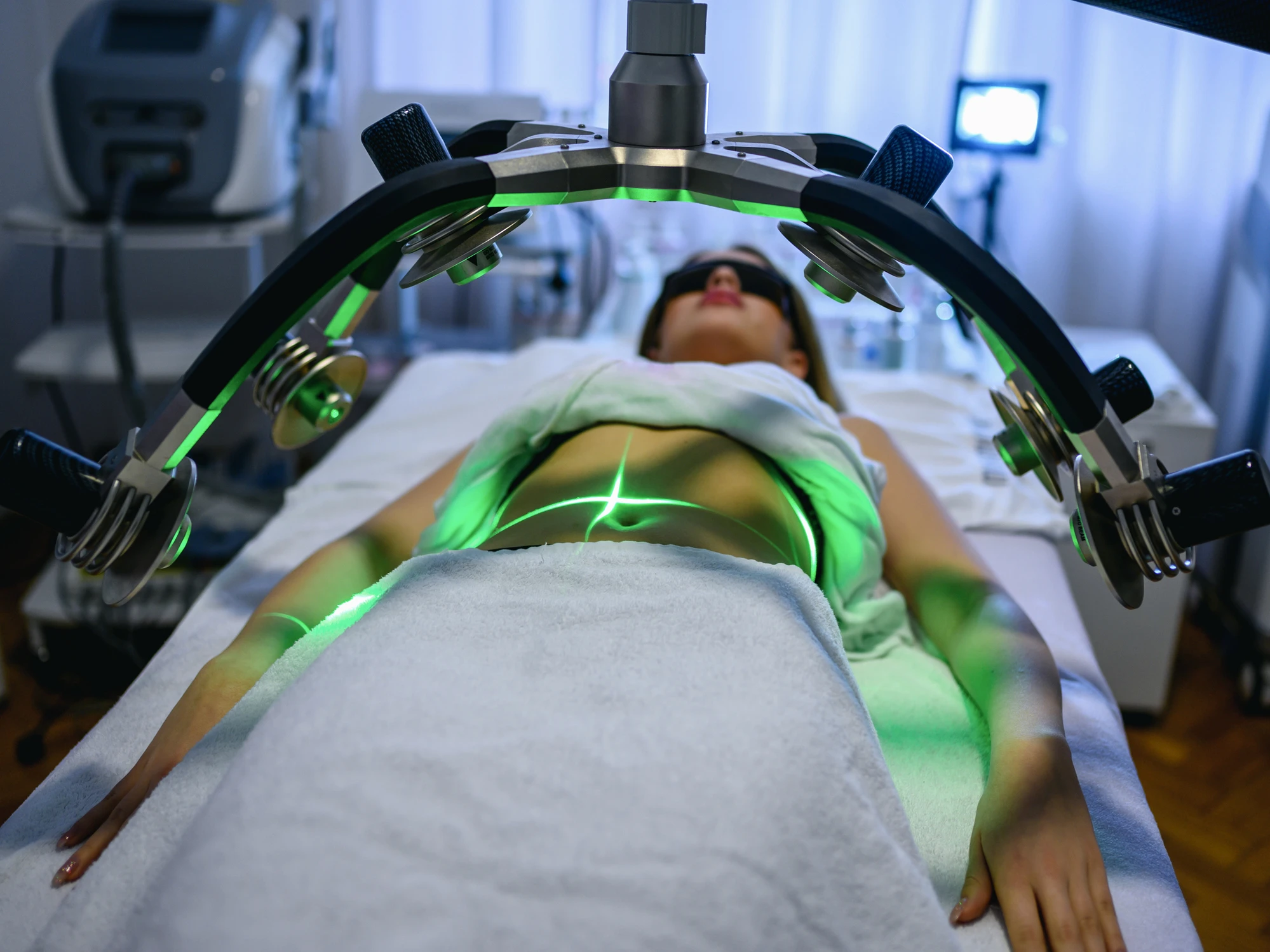 Woman undergoing laser treatment in clinic.