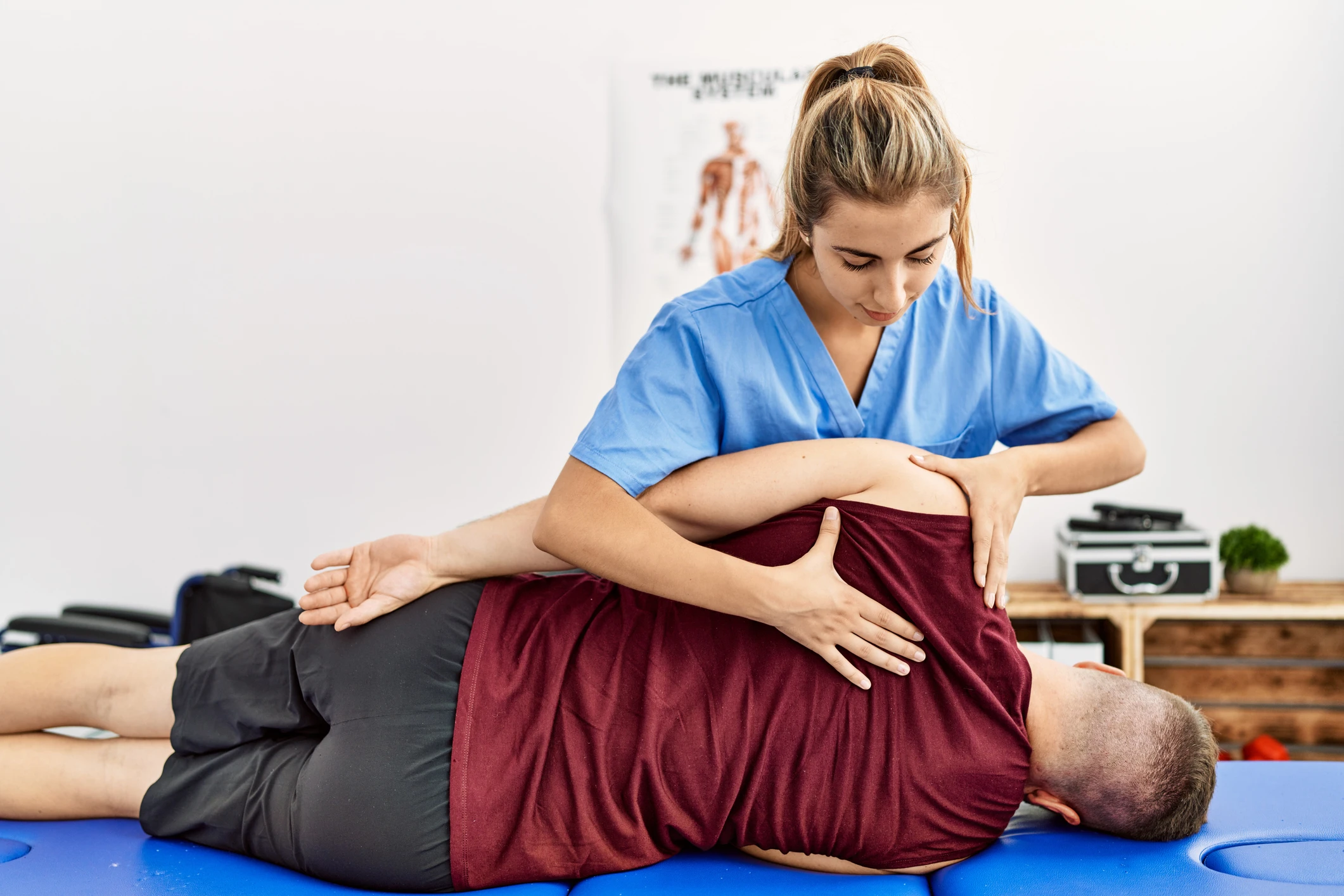 Physiotherapist assisting patient with back therapy.
