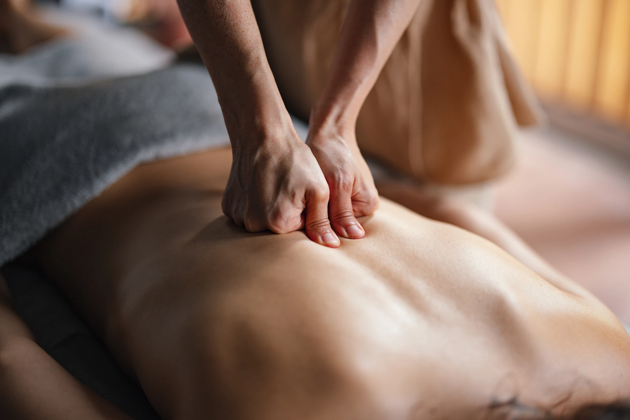 Back massage with pressing technique in progress.