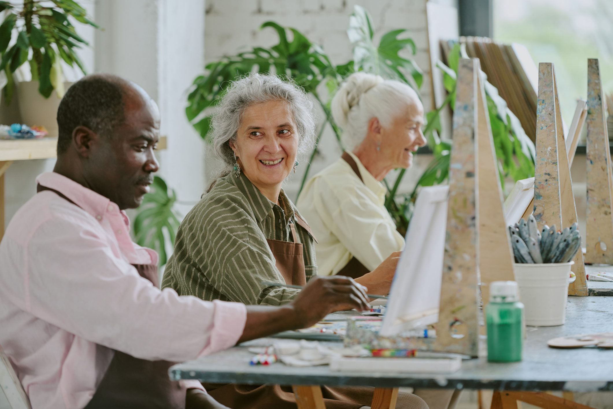 Elders painting together in an art class.