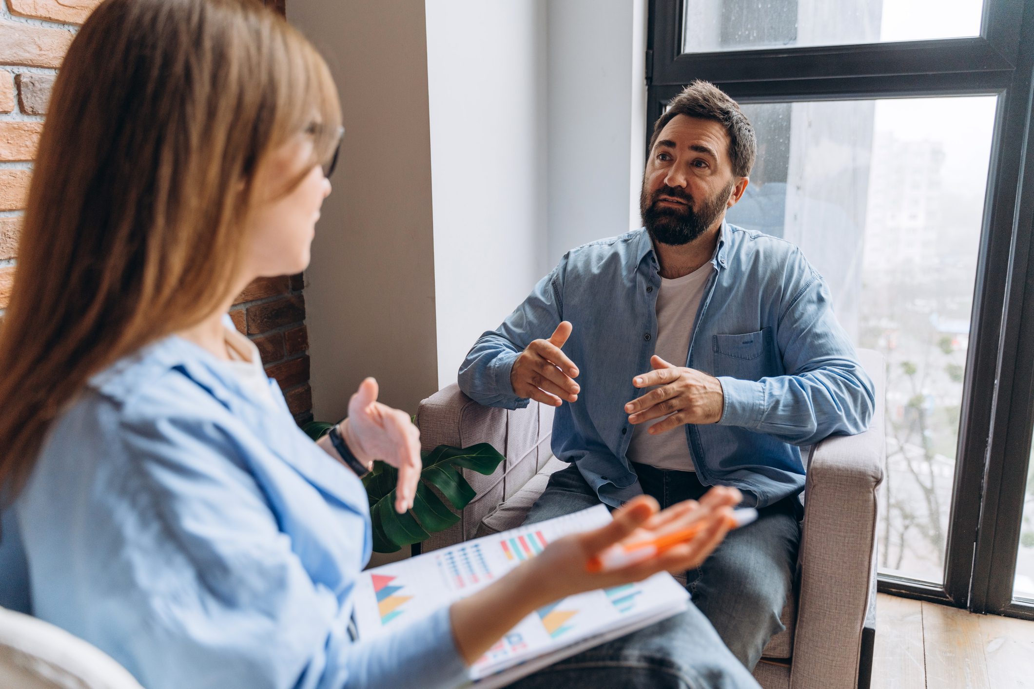 Two people having a focused conversation indoors.