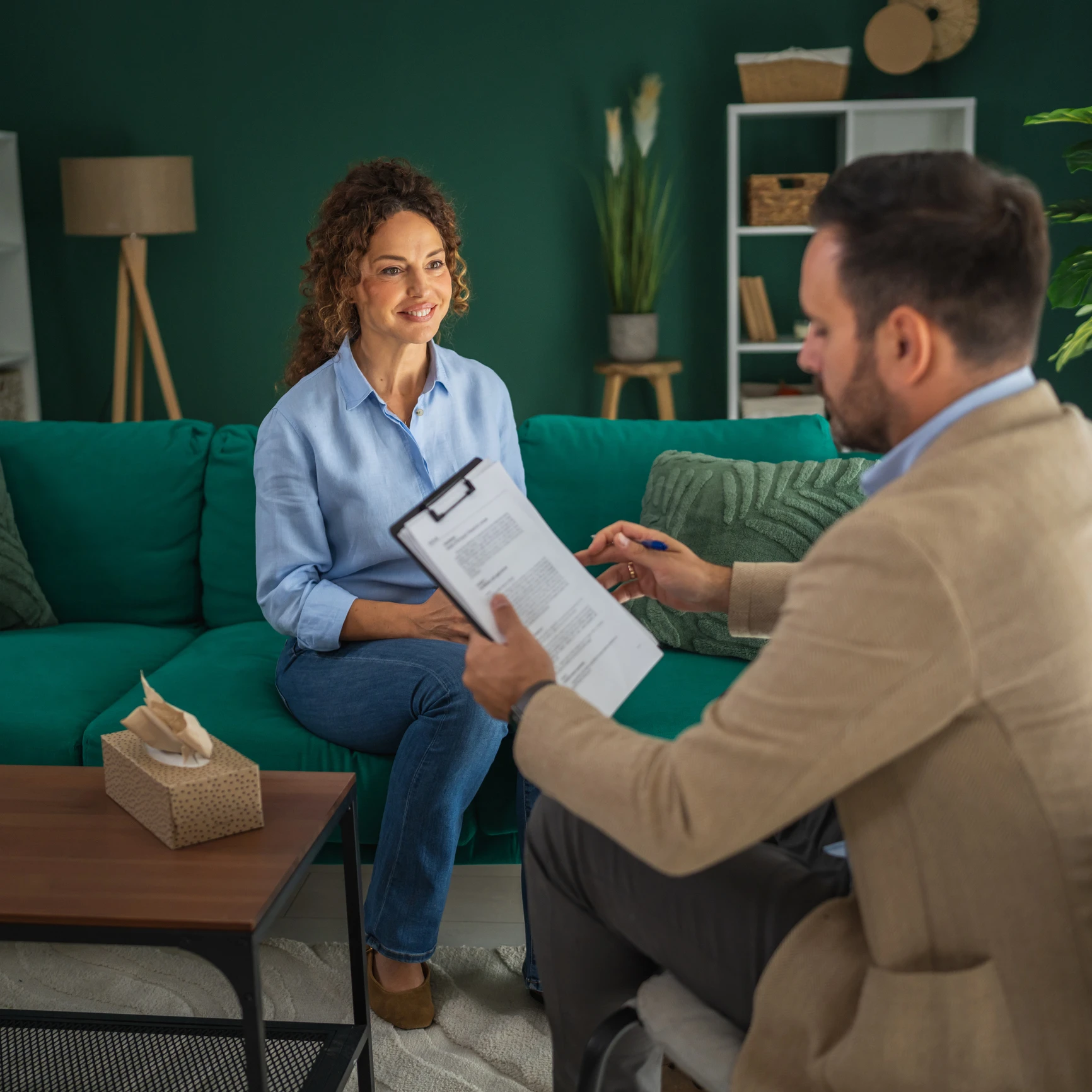Man and woman talking in living room.