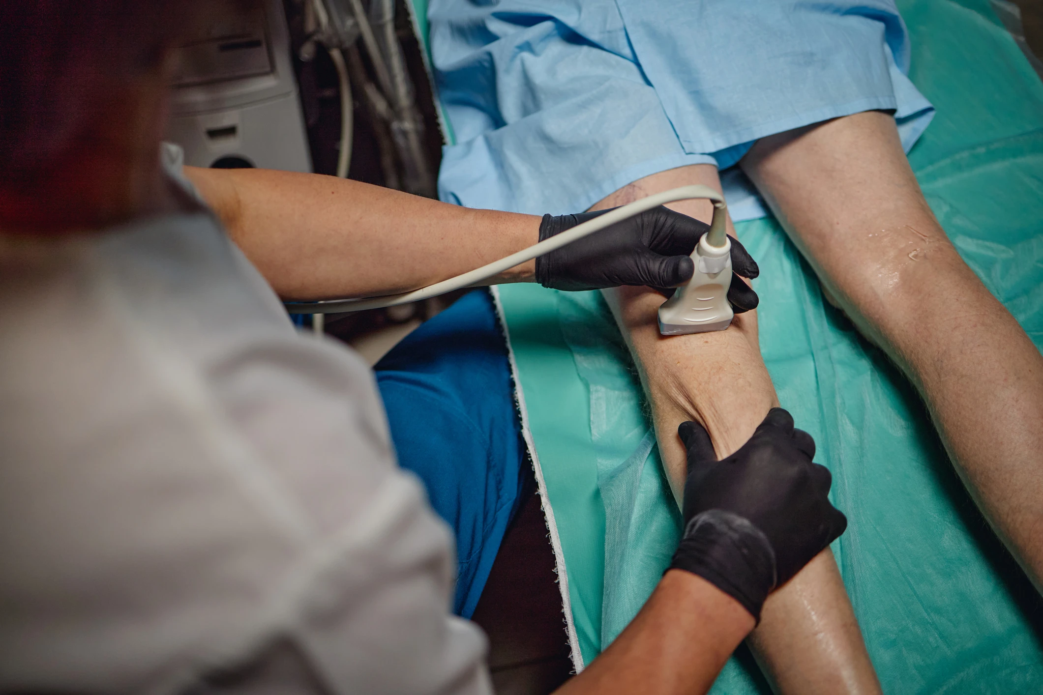 Ultrasound examination on patient's leg.