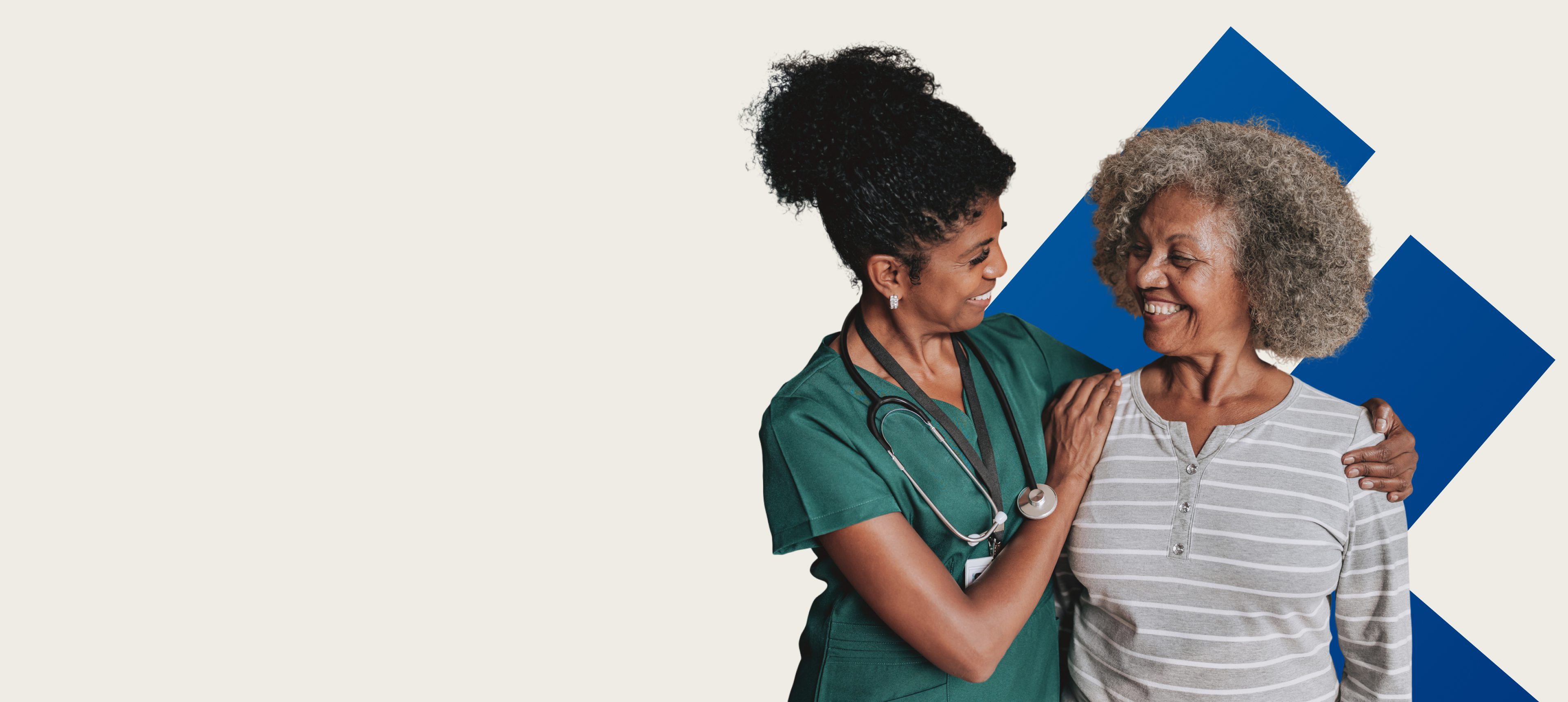 Nurse comforting elderly woman, both smiling.