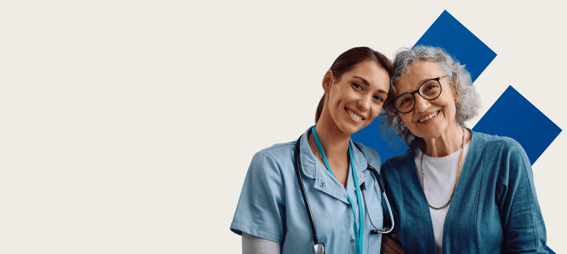 Nurse smiling with elderly woman, blue background.