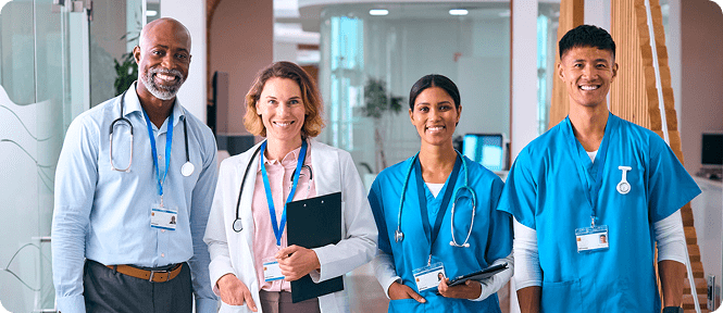 Healthcare professionals standing together, smiling confidently.